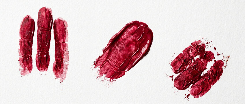 Red Lipstick Swatches, Smears, and Fingerprints on White Paper