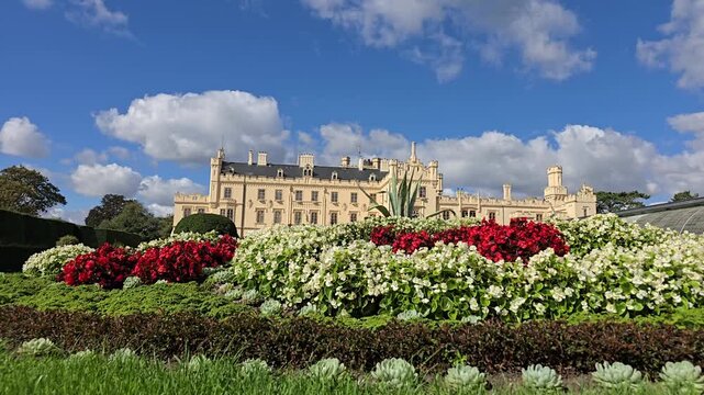 Time lapse of Lednice Castle and blooming floral gardens under clouds