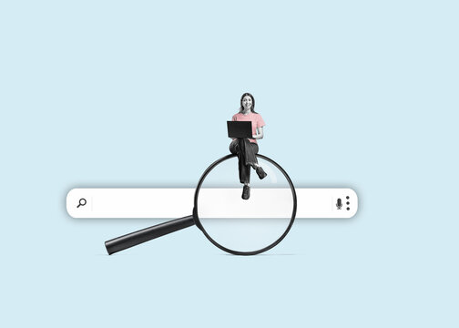 A young woman with a laptop on a big magnifying glass. Isolated free search area. Searching for information on the internet concept.