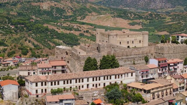 Santa Severina castle parallax orbit aerial drone reveal in Calabria Italy 4K. Telephoto POI rotation around medieval Norman fortress to front facade. Historic borgo hidden gem