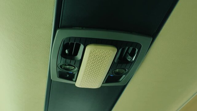 Overhead bus air vents and passenger reading lights in close view. Modern coach ceiling service unit with paired ventilation nozzles. Intercity travel equipment above passenger seats inside cabin