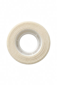 Roll of White Medical Adhesive Tape on Dark Surface