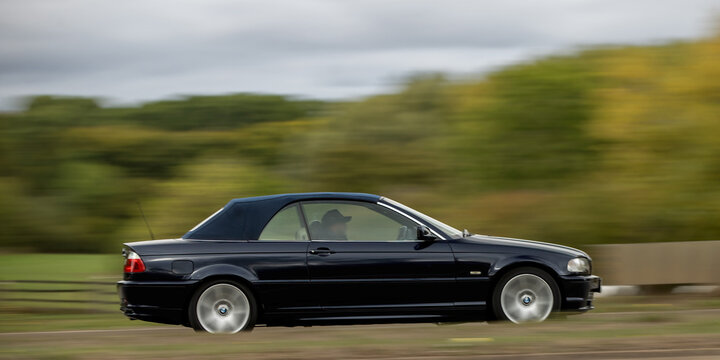 Milton Keynes; UK - Oct. 6th 2026: 2001 blue BMW 3series 330 ci convertible  car driving on a British road