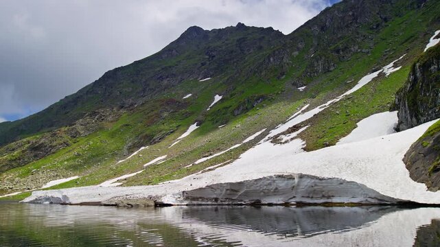 Windswept Balea Lake Beneath Snowy Fagaras Slopes