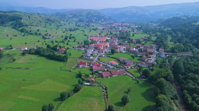 Aerial drone view of the summer countryside surrounding the village of Villacarriedo in the Pasiegos Valleys, Cantabria, Spain, Europe