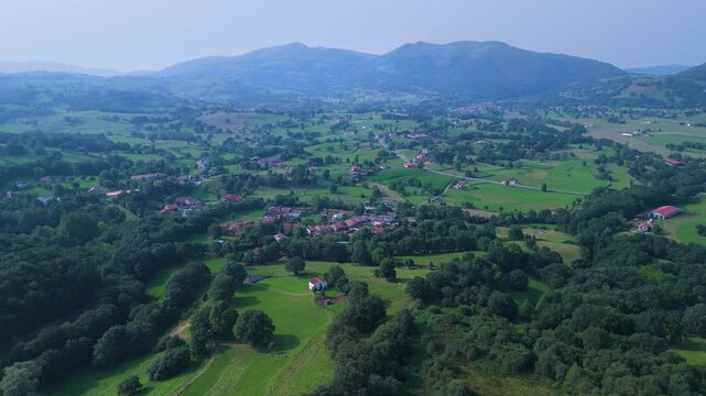 Aerial drone view of the summer countryside surrounding the village of Villacarriedo in the Pasiegos Valleys, Cantabria, Spain, Europe