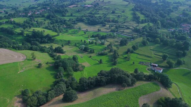 Aerial drone view of the summer countryside surrounding the village of Villacarriedo in the Pasiegos Valleys, Cantabria, Spain, Europe