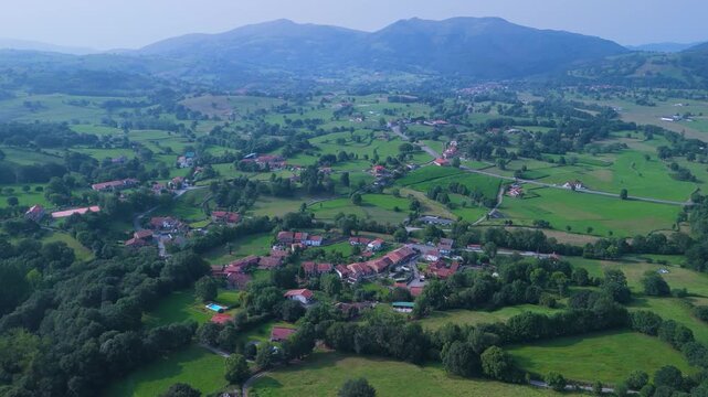 Aerial drone view of the summer countryside surrounding the village of Villacarriedo in the Pasiegos Valleys, Cantabria, Spain, Europe
