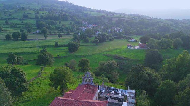 Aerial drone view of the summer countryside surrounding the village of Villacarriedo in the Pasiegos Valleys, Cantabria, Spain, Europe