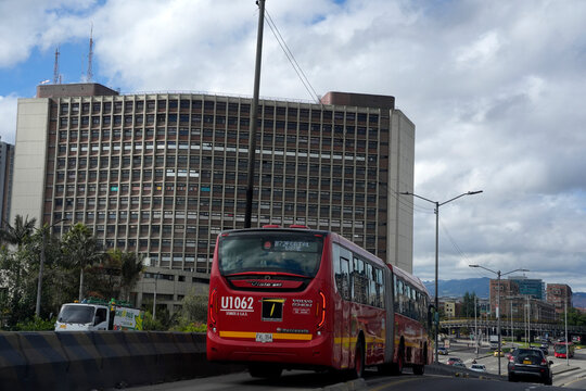 BOGOTA, COLOMBIA - NOVEMBER 1 2025: TransMilenio BRT Red Bus on Bogota Urban Highway Colombia