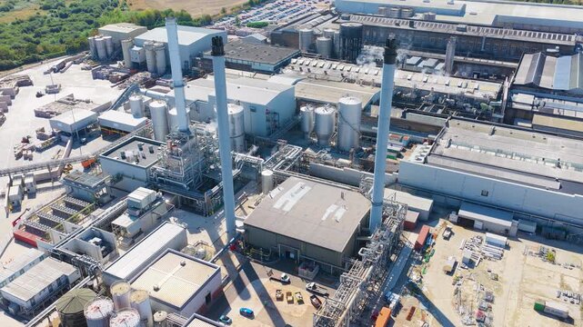 Aerial View of Paper Mill With Smoking Chimneys