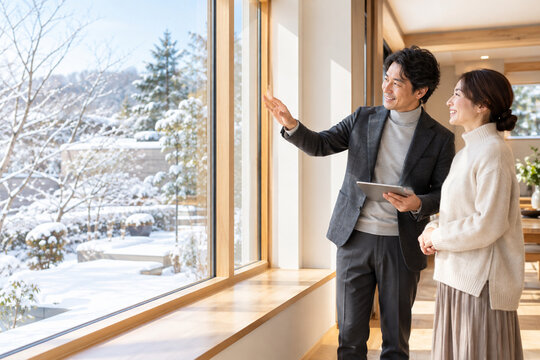 Architect and homeowner inspecting energy efficient window renovation