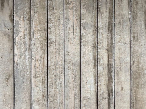 Weathered vertical wooden planks with peeling paint, textured rustic background