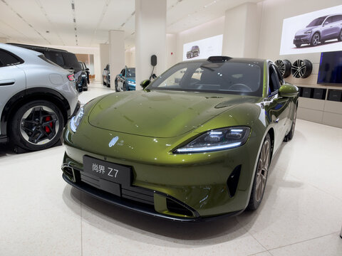 Shenzhen, China - September 21, 2026: Olive green Shangjie Z7 electric sedan in car showroom