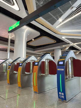 Shenzhen, China - September 21, 2026: Vertical Subway fare gates in blue and orange with exit sign