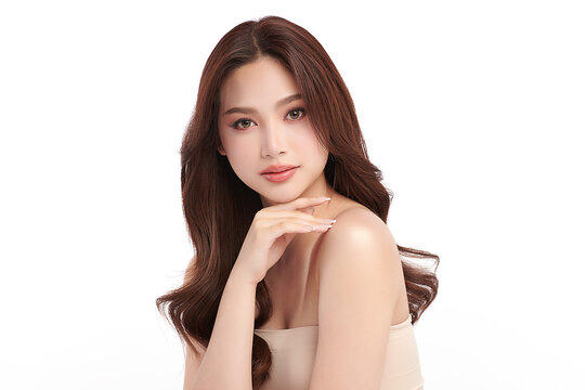 A beautiful young Asian woman with clean, fresh skin against a white background. Skincare, facial treatment, cosmetology, beauty, and spa. An elegant portrait of an Asian woman.