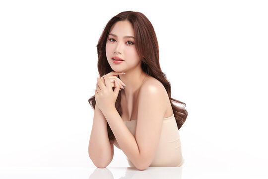 A beautiful young Asian woman with clean, fresh skin against a white background. Skincare, facial treatment, cosmetology, beauty, and spa. An elegant portrait of an Asian woman.