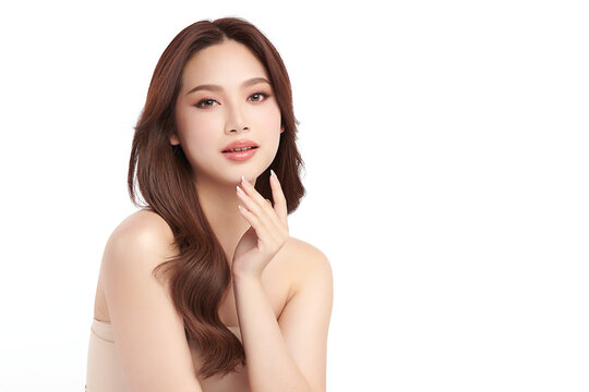 A beautiful young Asian woman with clean, fresh skin against a white background. Skincare, facial treatment, cosmetology, beauty, and spa. An elegant portrait of an Asian woman.