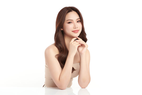 A beautiful young Asian woman with clean, fresh skin against a white background. Skincare, facial treatment, cosmetology, beauty, and spa. An elegant portrait of an Asian woman.