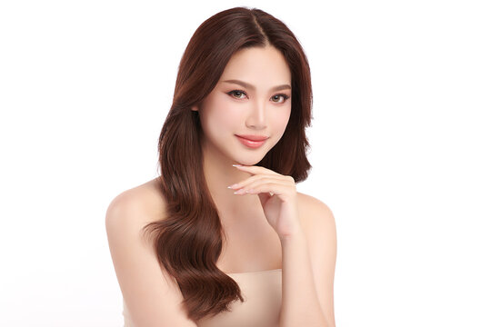 A beautiful young Asian woman with clean, fresh skin against a white background. Skincare, facial treatment, cosmetology, beauty, and spa. An elegant portrait of an Asian woman.