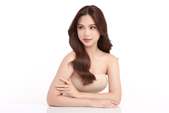 A beautiful young Asian woman with clean, fresh skin against a white background. Skincare, facial treatment, cosmetology, beauty, and spa. An elegant portrait of an Asian woman.