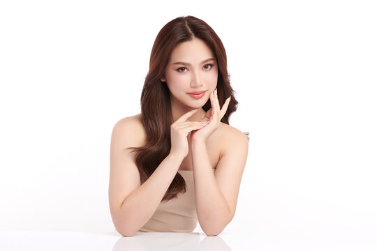 A beautiful young Asian woman with clean, fresh skin against a white background. Skincare, facial treatment, cosmetology, beauty, and spa. An elegant portrait of an Asian woman.