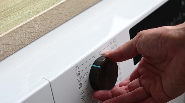 Selecting eco wash program on washing machine control panel