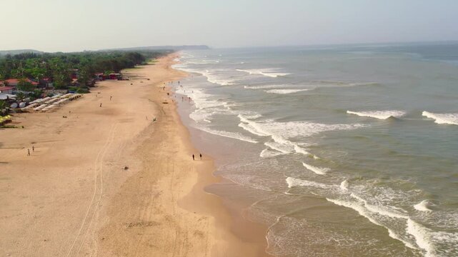 Aerial drone view of Mandrem Beach in Goa India with ocean waves