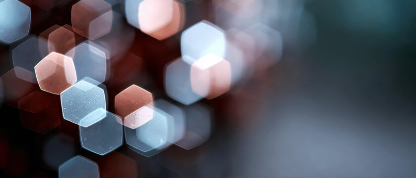 Soft blush and gray hexagonal bokeh shapes with water droplets fading into a muted background