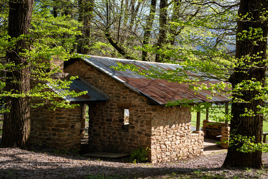 Rustic Stone Cabin Surrounded By Lush Greenery