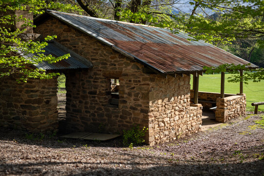 Rustic Stone Cabin Surrounded By Lush Greenery
