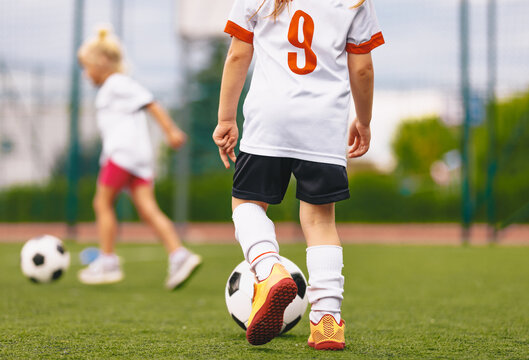 Back View of Youth Soccer Player in White Jersey Number 9 Controlling Ball on Outdoor Pitch - Junior Football Skill Drill