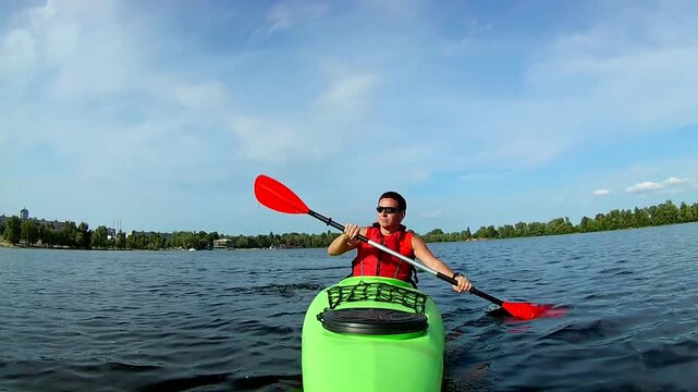 Man kayaking on a calm lake