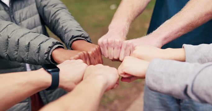Circle, friends and hands with fist bump at park for social connection, solidarity and community. Unity, people or huddle together with gesture for friendship cohesion, belonging or inclusion outdoor