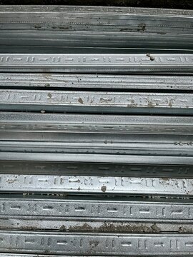 Close up view of stacked galvanized light steel studs and channels used for modern building frame construction project background