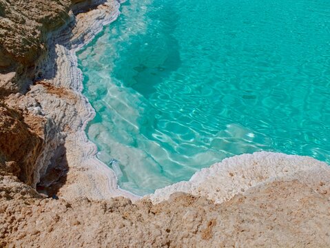 Close Up of White Salt Crystals Formation and Crystal Clear Turquoise Water