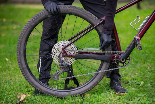 Cyclist Repairing Mountain Bike Rear Wheel Outdoors