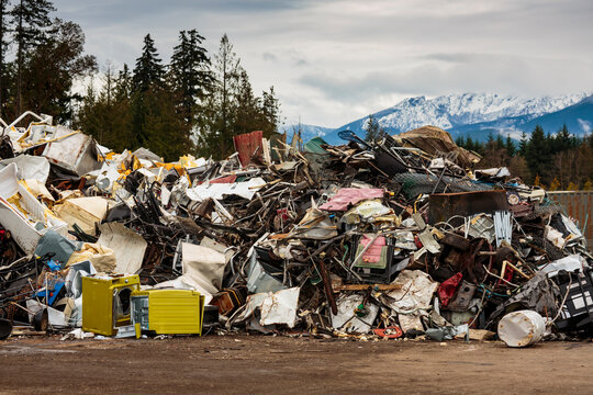 Large pile of washing machines, refrigerators and metal heap in a recycling plant, white goods and meta recycling.