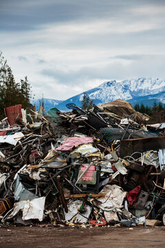 Large pile of washing machines, refrigerators and metal heap in a recycling plant,