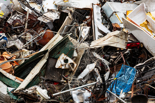 A recycling centre, white goods and rubbish, garbage piled up for recycling. 
