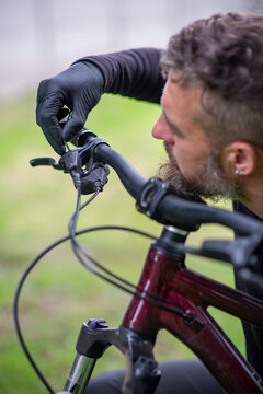 Man Adjusting Bike Brake Lever on Handlebar