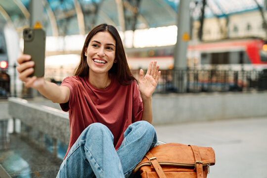 Young Woman Using Phone In A Subway Station