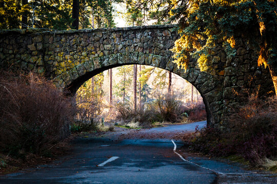 Stone bridge over a road in Manito Park, Spokane, autumn foliage and colours.