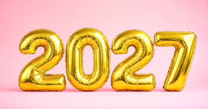 Shiny gold foil balloons spelling year two thousand twenty seven
