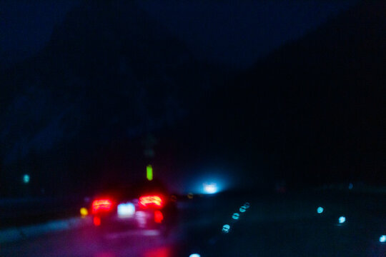 Night driving, limited visibility in the darkness, the wet road surface of Interstate 90 through the Cascade Mountains.