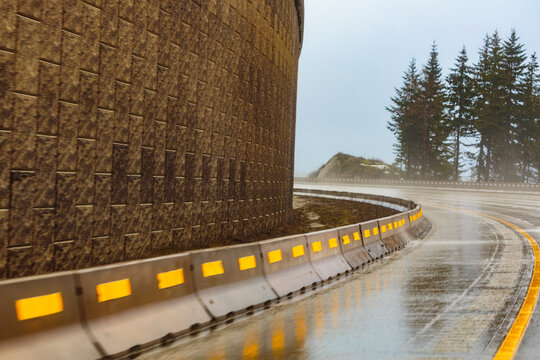 Eastbound route on Interstate 90 through the Cascade Mountains, a sharp corner and wet road.