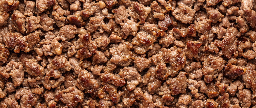 Minced beef meat cooked brown texture background for culinary recipes and food projects