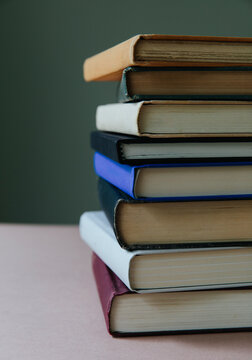 Stack of old hardcover books, spines showing, close up