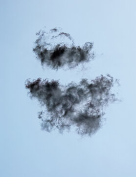 Cumulous cloud, a clump of wispy grey clouds in a pale blue sky.