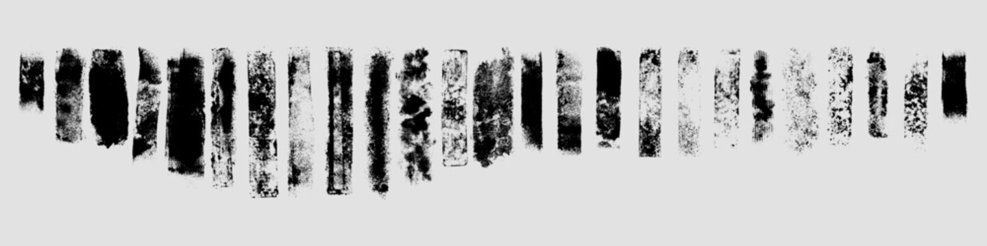 A horizontal row of irregular black brush marks with distressed edges and speckled ink texture arranged as a grunge collection on a pale gray background